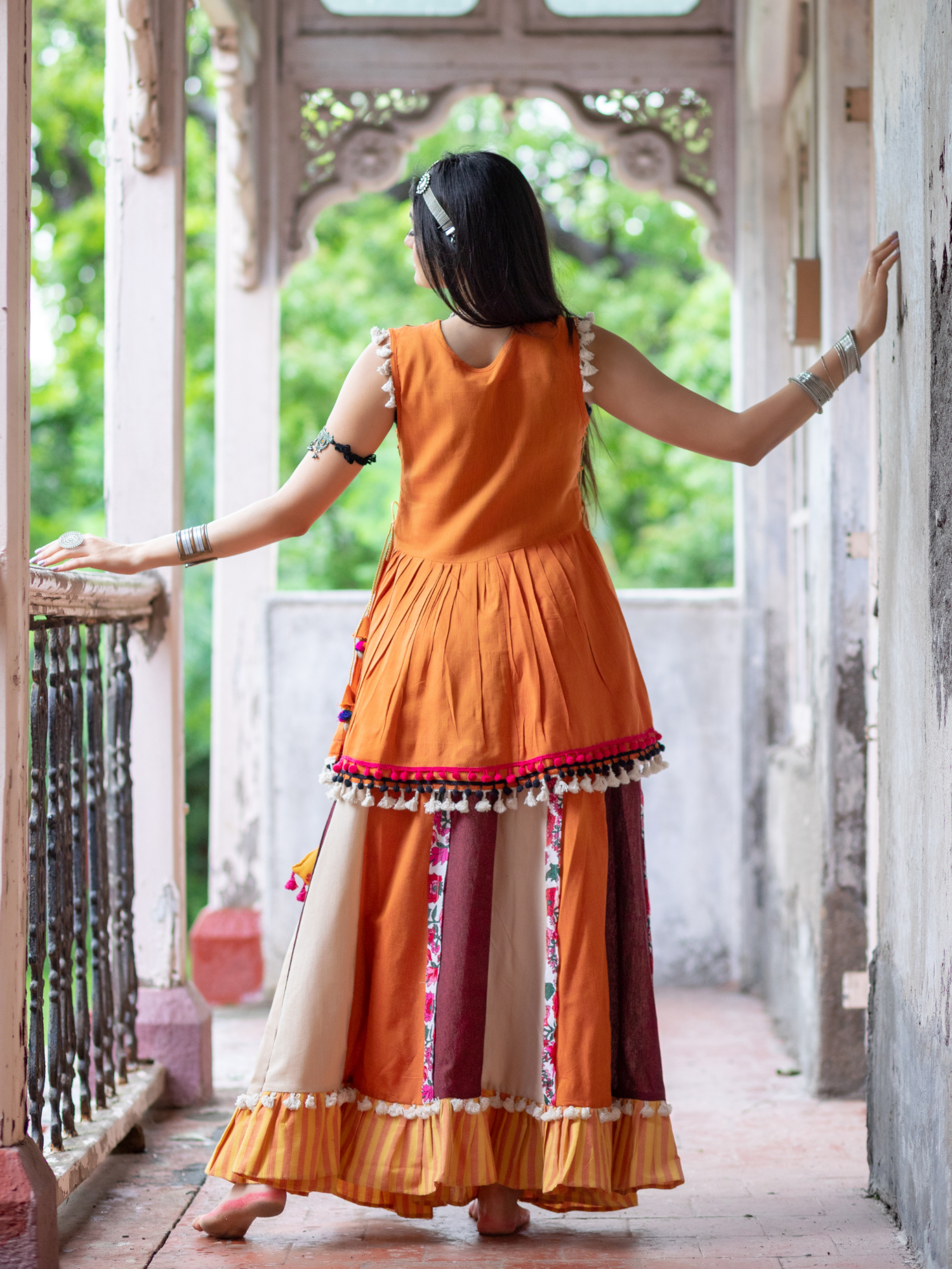 Eye catchy orange embroidered peplum style top with colorful flairy skirt