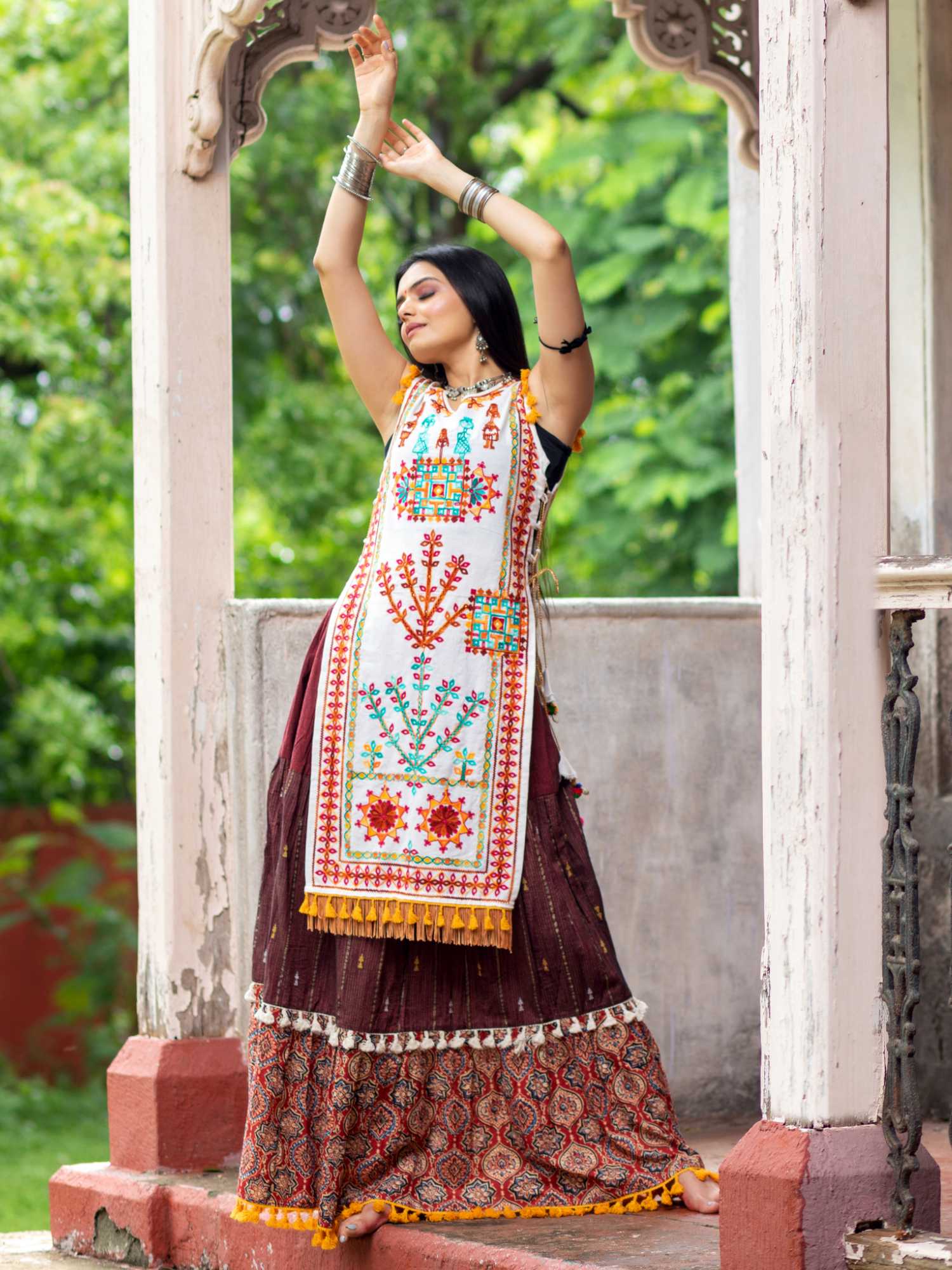 Off white dhingli motif embroidered panel top paired with wine trendy printed skirt